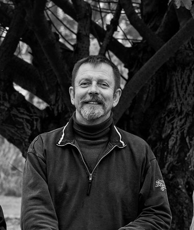 A black and white picture of Alan smiling